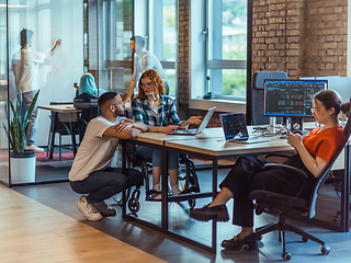 Image showing A diverse group of young business individuals congregates in a modern startup coworking center, embodying collaborative innovation and a dynamic atmosphere