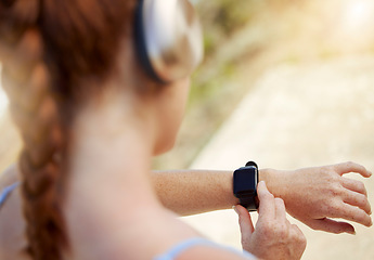 Image showing Fitness woman, smartwatch and sports woman outside tracking progress for exercise, cardio training and outdoor workout for health. Closeup active female athlete using mobile music app to track steps