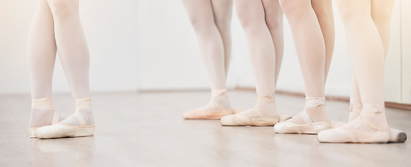 Image showing Ballet, leader and dancer group feet in dance studio training in artist academy with white wall and floor. Women team, class or students dancing on pointe shoes for school performance with lens flare