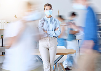 Image showing Covid, busy office and business woman portrait with face mask rules for staff safety, healthcare and corona virus risk in modern office. Motion blur, fast moving people and corona virus workplace job