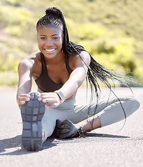 Image showing Sport, fitness and stretching with a sports woman getting ready for a workout, exercise or training on a road outside. Health, wellness and stretch with a female athlete at the start of a routine