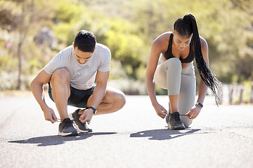 Image showing Exercise, motivation and woman with personal trainer start run in nature, cardio health in summer. Tie shoes, energy and wellness workout with man asian man and black woman training in a road