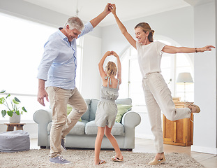 Image showing Girl dance with grandparents on living room, have fun and happy time in home. Senior man, smile in house with woman and child, dancing and playing together in their lounge at family home
