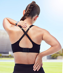 Image showing Fitness woman back pain, spine injury and neck problems at sports training stadium outdoors. Athlete fracture, health emergency and scoliosis risk from exercise workout, body stress and muscle bruise