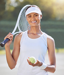 Image showing Tennis, fitness and sport woman with racket for training, exercise and workout on tennis court. Portrait, smile and motivation with tennis ball for energy, health wellness or winner mindset for match