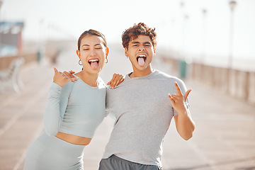 Image showing Man and woman friends with tongue out, happy and crazy together in city after fitness workout outdoor in sunny summer. Funny, comic and Japanese Asian young people smile, hug and love for friendship