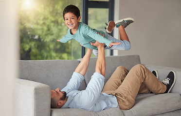 Image showing Happy family, love and father and son bonding on a sofa at home, playing and being creative with a fun game. Energy, fantasy and airplane pose by happy boy enjoying free time with his caring dad