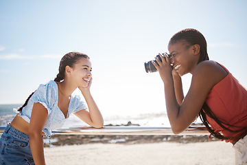 Image showing Summer, photographer and friends at a beach, having fun and posing for photograph on a sea trip together. Travel, happy and women bonding on a Florida vacation, relaxed and cheerful in with a camera