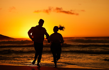 Image showing Fitness, beach and couple silhouette running at sunset, training in water and health workout. Love, sunrise and woman and man bond while exercise along the sea, healthy lifestyle with morning cardio