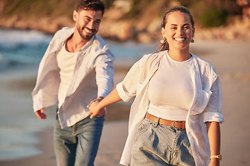 Image showing Happy couple, beach and travel while holding hands, laughing and having fun on Portugal summer vacation or holiday traveling to seaside. Smile of man and woman on honeymoon sharing love and adventure