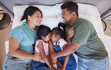 Image showing Family, bedroom and kids having fun bonding and lying in bed with their happy parents while laughing, relax and resting in singapore home. Man, woman and girl children, twins or sisters being playful