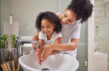 Image showing Family, washing hands and child with mom rinsing, cleaning and good hygiene against bacteria or germs for infection or virus protection in bathroom. Girl kid with woman for health and cleanliness