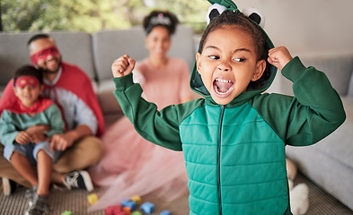 Image showing Child, fun and dress up for Halloween with energetic, brave and strong girl playing dress up wearing costume with family at home. Energetic, playful and imagination of kid during pretend game