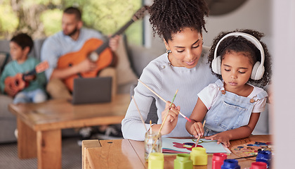 Image showing Creative family, mom and girl doing art and craft with dad and in background with guitar in home. Painting, child development and parents love for children, a mother from brazil and kid with paint.