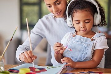 Image showing Mother, girl and bonding in painting activity with music headphones, radio or audio for autism help. Brazilian woman, art parent and creative child listening to relax autism podcast in house or home