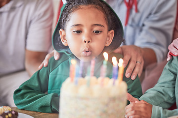 Image showing Birthday, cake and girl with candles, happy and excited at a party celebration with family. Children, event and birthday party fun by child blowing and enjoy birthday cake candle and her special day