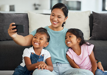 Image showing Selfie, family and children with a girl, daughter and foster mother taking a photograph in a living room of the home. Kids, love and affection with a woman, sister and sibling together in a house