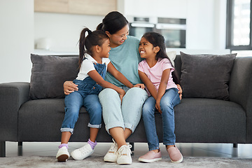 Image showing Family, love and single mother with kids looking happy, relax and smiling sitting together and bonding on sofa in lounge at home. Asian babysitter woman hugging cute girls, daughters or twin sisters