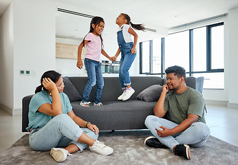 Image showing Family, energy and kids jumping on home sofa with tired parents struggling with naughty, hyperactive and playing children. Woman and man with ADHD, noisy and laughing girls, friends or fun twins