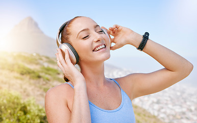 Image showing Fitness, nature and a woman with headphones listening to music with smile and mountain background. Exercise, streaming app and a workout playlist online. Summer sky, sun and happy training with song.