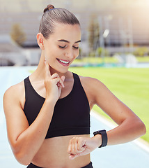 Image showing Sport, watch and time with a sports woman training during a workout and checking or tracking her progress. Health, fitness and wellness with a young female athlete timing her performance on a run