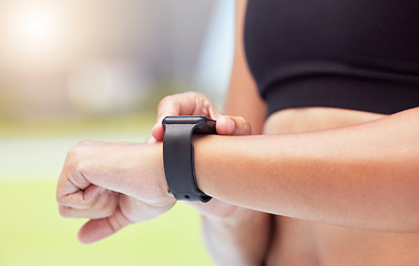 Image showing Smartwatch on hands of runner to track woman running time, health stats and train for competition race. Smart watches help competitive performance, motivate and inspire athlete to improve record time