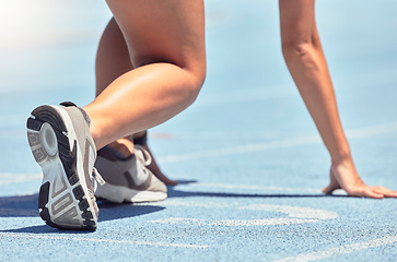 Image showing Running, shoes and start with a sports woman or female runner on a track for a workout, exercise or training. Fitness, run and cardio with an athlete getting ready for a competition or race outside