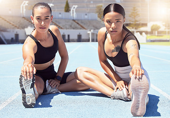 Image showing Fitness, stadium and women stretching hamstring on racetrack ready to start training, exercise and cardio workout. Wellness, girls and portrait of healthy runners at a sports competition in summer