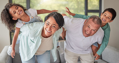 Image showing Family, kids and piggy back with grandparents, fun and smiling in living room. Grandma and grandpa spending quality time with children on weekend. Happy senior man and woman playing with boy and girl