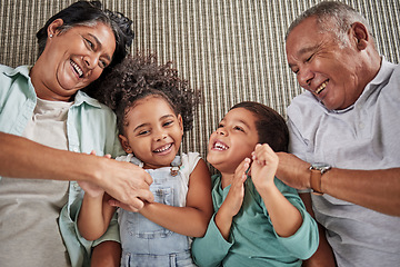 Image showing Happy family, grandparents and children on a sofa, relax and laughing while bonding in e living room together. Love, laugh and happy kids playing, enjoy time and fun game with elderly man and woman