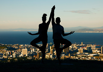 Image showing Couple, silhouette and yoga in spiritual fitness and wellbeing against a city background. Dark shadow of people in meditation exercise balance together in healthy mind, body and spirit in calm nature