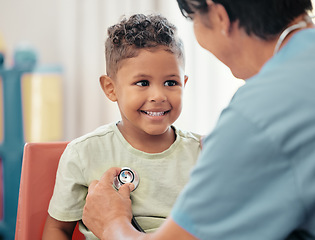 Image showing Children, healthcare and stethoscope with a doctor or pediatrician listening to the heartbeat of a boy patient in the hospital. Nurse, medical and trust with a male child and female consultant