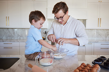 Image showing Father, son and baking teamwork on kitchen counter together love to bond, food and cooking flour, milk and egg pastry. Fun, smile and happy dad teaching kid healthy cookies bake recipe in family home