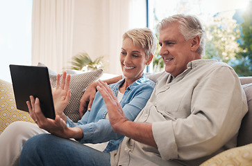 Image showing Senior couple digital tablet, wave and video call with a talking on the sofa in the living room. Video conference with elderly man and woman smile, happy and conversation online with virtual chat