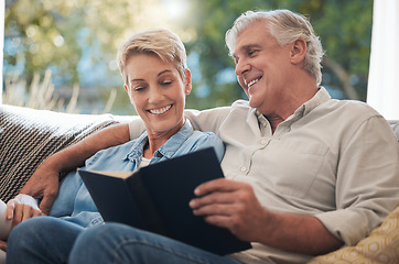 Image showing Senior, pension and reading couple with a happy smile at home on a lounge sofa. Love, calm and happiness mindset of a elderly couple with books together looking at pages of a book on a house couch