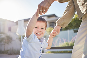 Image showing Portrait of a child in the street with mom holding hands and playing together. Mother and her kid having fun outside, in summer and the child is happy and smiling. Love, family and bonding with son