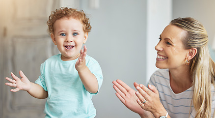 Image showing Happy clapping, mother support and kid with energy in living room, smile for celebration and family love in lounge of house. Portrait of baby with joy and applause during child development with mom