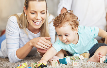 Image showing Mother, kid and play learning block toys on floor for educational bonding time together in family home. Young, caring and loving woman helping toddler with child development and coordination skills.