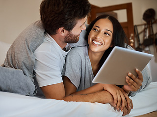 Image showing Happy couple, smile and tablet in bedroom entertainment, love and care relaxing together at home. Man and woman smiling for fun bonding time streaming on wifi in bed with touchscreen technology