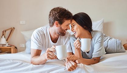 Image showing Love, happy and a couple with coffee in bed on beautiful morning at home. Weekend, wake up and smile, woman and man relax with hot drink in bedroom. Romance, happiness and drinking sweet tea together