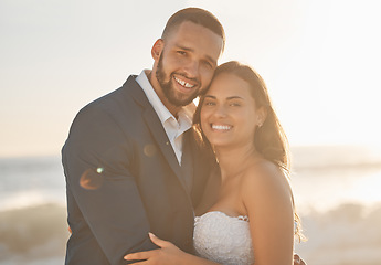 Image showing Love, couple and wedding portrait of bride and groom hug and bonding at beach, happy and cheerful. Freedom, romance and just married couple excited for ocean trip and honeymoon, celebrating marriage