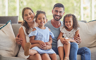 Image showing Happy, smile and portrait of a family bonding in the living room to relax on the sofa together. Happiness, care and parents sitting and holding their girl children with love on a couch at home.