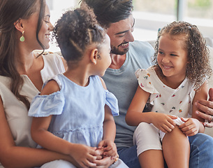 Image showing Interracial family, kids smile and parents on living room sofa with love, happy with girl children and together in house. Young sisters laughing in happiness with mother and father in home lounge