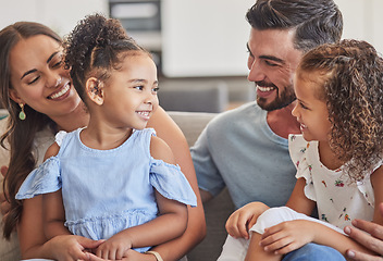 Image showing Family, smile and love of children for their mom and dad while sitting together in the lounge at home sharing a special bond. Happy interracial man, woman and girl kids hug their parents in Brazil