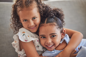 Image showing Happy, smile and portrait of sisters hugging while sitting on a sofa in the living room at the family home. Happiness, love and girl siblings from puerto rico bonding while relaxing on couch together