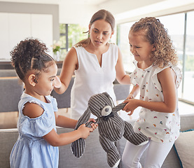 Image showing Toys fight, angry children and mother confused about kids in conflict, talking about problem and family communication in house. Girl siblings upset about teddy bear with mom in home living room