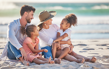 Image showing Interracial family, beach vacation and travel with children and parents sitting in sand enjoying summer holiday in maldives. Man, woman and girl kids having fun and feeling happy on a tropical trip