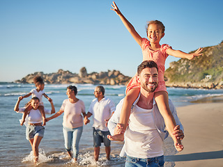 Image showing Happy, travel and love with big family at beach for Colombia holiday for summer, relax and support. Sunset, nature and smile with parents, kids and grandparents walking by the sea for vacation