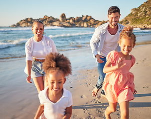 Image showing Beach, summer and travel with family running on sand in Mexico for vacation fun with kids. Happy mother and father bond together chasing excited children on ocean holiday break in the sun.