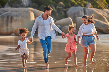 Image showing Love, freedom and family at the beach, walking and holding hands, relax in water and nature. Freedom, wellness and vacation with happy family laughing and bond, enjoy walk in sand and time together